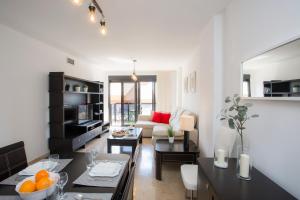 a living room with a couch and a dining room at SingularStays Artes in Valencia