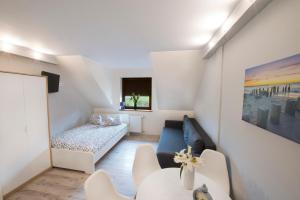 a living room with a couch and a table at Villa Agawa in Niechorze +64 photos