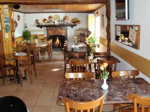 a restaurant with tables and chairs and a fireplace at Ristorante Bellavista in Santa Maria