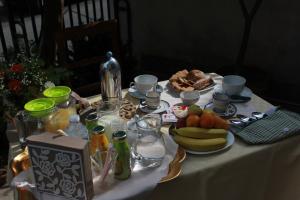 a table with a white table cloth with food on it at B&B Betania in Riposto