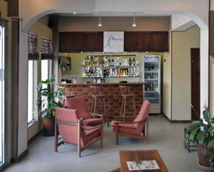 a bar in a restaurant with chairs and a counter at A l'hotel in Antananarivo