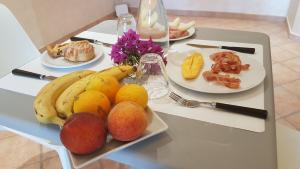 a table with a plate of fruit on it at Residenza Dama in Santa Domenica