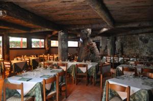 a restaurant with tables and chairs in a room at Hotel Residence Moneglia in Moneglia