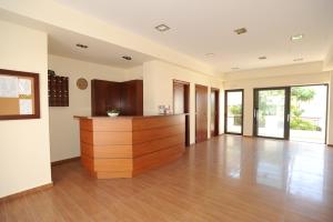 a large living room with wooden floors and glass doors at Georgina in Agia Marina Nea Kydonias