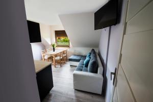 a living room with a couch and a table at Villa Agawa in Niechorze