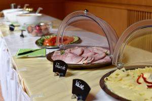 
a table with plates of food on it at Junges Hotel Tulln in Tulln
