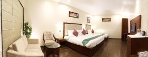 Ένα ή περισσότερα κρεβάτια σε δωμάτιο στο Hotel Tridev
