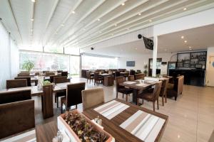 a restaurant with tables and chairs and a large window at Blueberry Boutique Hotel in Fethiye