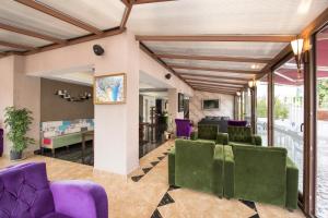 a living room with purple and green chairs at Blueberry Boutique Hotel in Fethiye