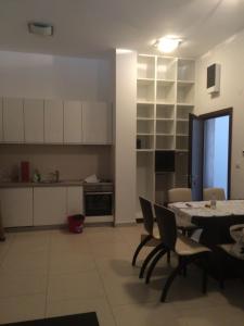 a kitchen and dining room with a table and chairs at Lavender Bay Apartment Dee B02 in Donji Morinj