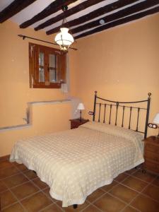 a bedroom with a large bed in a room at Casa rural L'Hospital in Vistabella del Maestrazgo