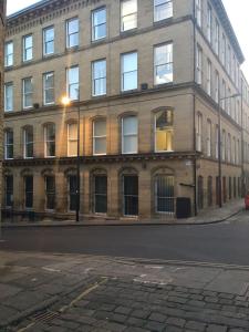 a large brick building on the side of a street at Premier Apartments in Bradford