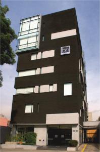 a black building with a sign on the side of it at Hotel bh Parque 93 in Bogotá