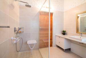 a bathroom with a shower and a sink at Swallows Nest Country Cottages in Stormsrivier