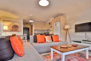 a living room with a couch and a table at Kasinn Apart Turuncu in Kaş