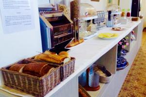 a bakery counter with bread in baskets on it at Arianna Hotel in Marina di Pietrasanta