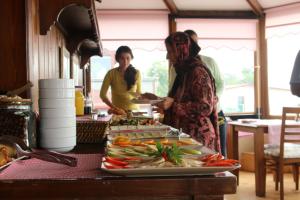two women standing in a kitchen preparing food at Emine Sultan Hotel in Istanbul