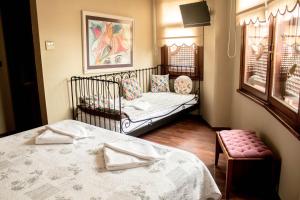 a bedroom with two twin beds and a crib at Emine Sultan Hotel in Istanbul