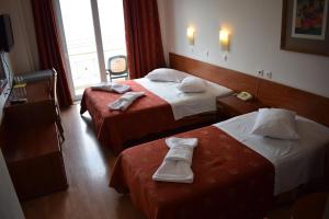 Postel nebo postele na pokoji v ubytování Hotel Kiani Akti