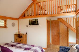 a bedroom with a bed and a wooden staircase at The Grove Cromer in Cromer