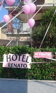 a sign for a hotel reattoria with pink balloons at Hotel Renato in Sesto San Giovanni