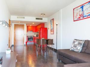 a living room with a couch a table and a kitchen at Apartamentos La Torre in Cambrils