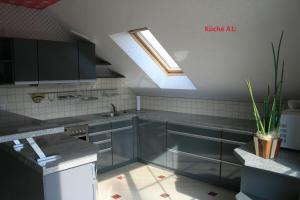 a kitchen with a sink and a skylight at Ferienwohnungen 99a in Weimar