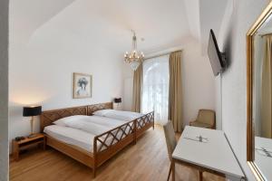 Postel nebo postele na pokoji v ubytování Hotel National Bern
