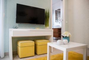 a living room with a tv on a wall at Batata - Ocean View in Nazaré