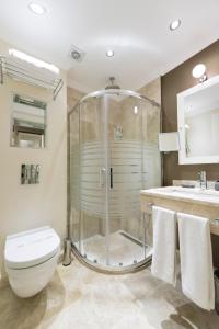 a bathroom with a shower and a toilet and a sink at Blueberry Boutique Hotel in Fethiye