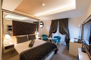 una camera d'albergo con un letto e un grande specchio di Blueberry Boutique Hotel a Fethiye