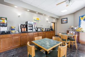 a restaurant with a table and chairs and a counter at Days Inn by Wyndham Orangeburg in Orangeburg