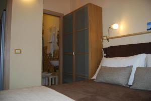 a bedroom with a bed with a large wooden headboard at Burlamacco Gold in Viareggio