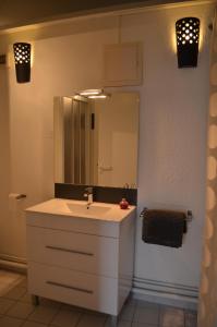 a bathroom with a white sink and a mirror at Maison Coetquen in Saint Malo
