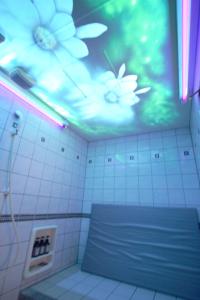 a bathroom with a ceiling with a painting of flowers at Hotel LaLa (Adult Only) in Sakai