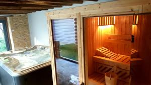 a small bathroom with a tub and a sink at Logis Hotel Archambeau in Thonac