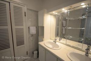 a white bathroom with a sink and a mirror at La Victoire de Noyers in Noyers-sur-Serein +76 photos