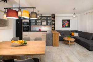 a living room and kitchen with a table and a couch at Villa Lipa Dora in Murvica