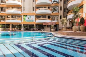 a swimming pool in front of a building at Monte Cairo Serviced Apartments in Cairo