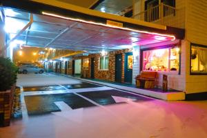 an empty parking lot in front of a building at night at Money Saver Motel in Newport