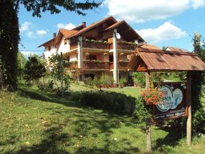 a house with a sign in front of it at Guest House Nena Rastoke in Slunj