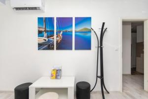 a room with a table and a picture of a boat at Hostel Petra Marina in Dubrovnik