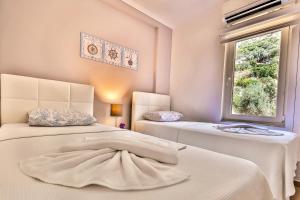 Postel nebo postele na pokoji v ubytování Kasinn Apart Hotel
