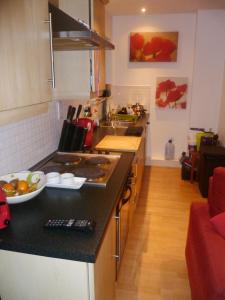 a kitchen with a counter with a bowl of fruit on it at Luxury Town Centre Apartment in Kinsale