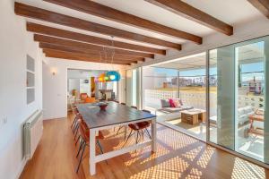 a dining room with a table and a living room at Villa Oasis Terra Blanca in Palma de Mallorca