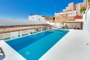 a swimming pool on the roof of a building at Villa Oasis by PriorityVillas in Palma de Mallorca