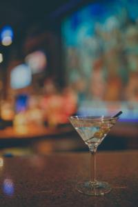 a martini glass sitting on top of a table at The Hotel Ottumwa in Ottumwa