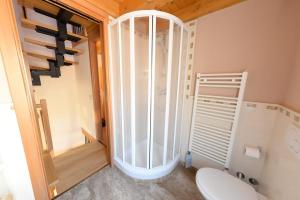 a small bathroom with a toilet and a shower at Piccola Venezia Apartments in Chioggia