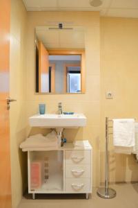 a bathroom with a sink and a mirror at Edimar 9 - Fincas Arena in Benidorm
