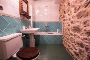 a bathroom with a sink and a toilet and a sink at Posada El Arrabal in Arenas de Iguña